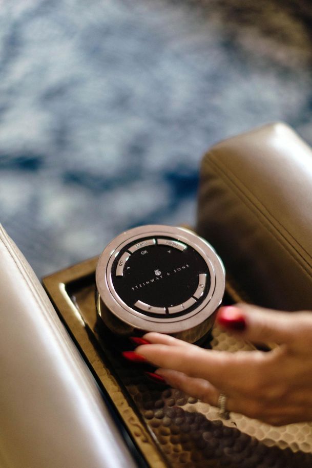 Woman's hand touching a Steinway & Sons control
