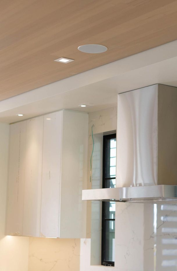 In ceiling speaker installed on a white marble kitchen